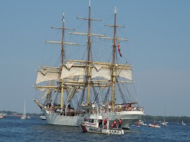 The S.S. Sorlandet, accompanied by harbour police, ends the pass-by.